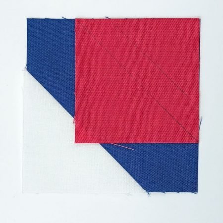 Adventure Quilt Along Block 5 featured by top US quilting blog and shop, Seams Like a Dream Quilt Designs: red, white and blue block doing stitch and flip