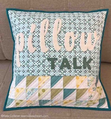 blue and green pillow with text