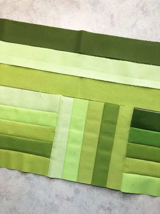 Strips made into small blocks for a runner with green strips auditioning for the borders.