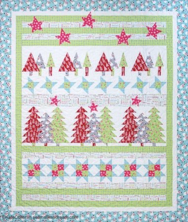 Top US quilting blog and shop, Kate Colleran Designs, shares about her plans for 2024! Quilt image is BOM pattern in red, blue, green and grey with different trees and stars