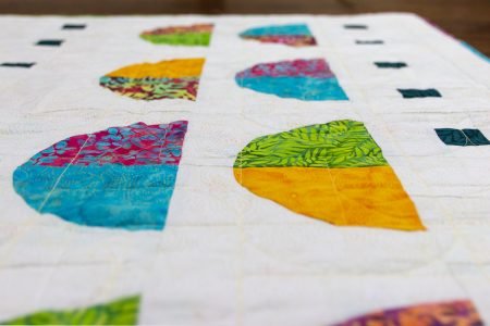 A New Quilt Pattern featured by top US quilting blog and shop Seams Like a Dream Quilt Designs, reveals their modern Drunkard's Path quilt Tropical Moon!