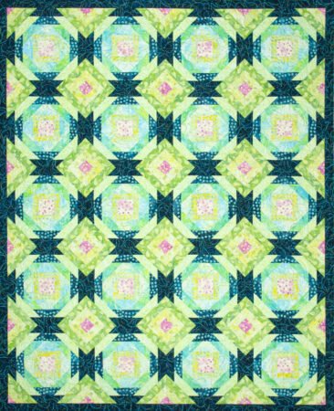 Top US quilting blog and shop, Kate Colleran Designs, shares about paper piecing quilts and her recent quilts. Pineapple Quilt shown in blues, greens with a pop of pink