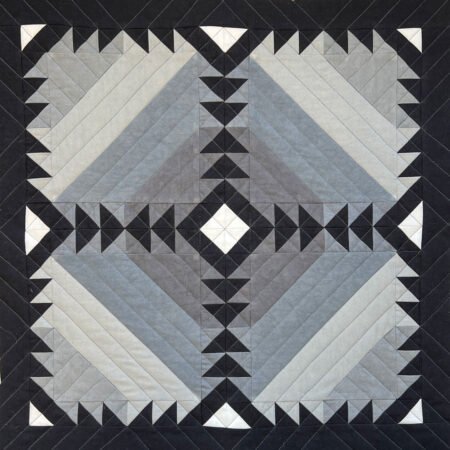 Top US quilting blog and shop, Kate Colleran Designs, shares about her remix of the Lady of the Lake quilt block! Image of a grey and black small quilt 