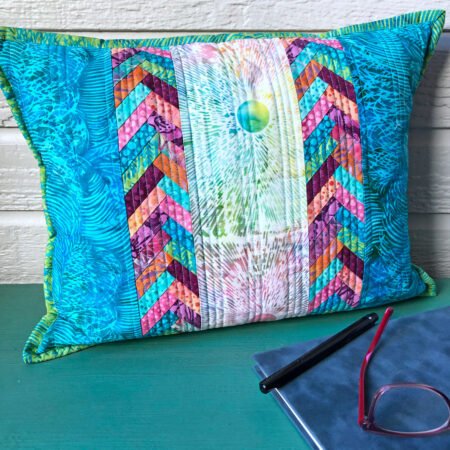 Top US quilting blog and shop, Kate Colleran Designs, shares about the Broken Glass and her projects in the batik fabrics! Snuggle Up pillow in aquas, pinks, green and white print