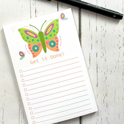 Top US quilting blog and shop, Kate Colleran Designs, shares about her plans for 2024! Image shown is a small notepad with a picture of a green and orange butterfly and the words Get it Done!
