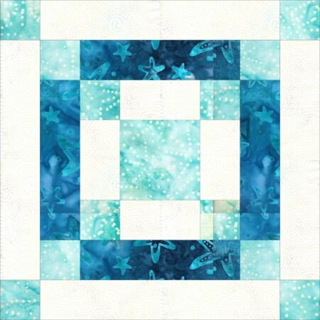 Top US quilting blog and shop, Kate Colleran Designs, shares about the January Quilt Block Remix Challenge and her fabric pull. Image is a quilt block with squares and rectangles in light blue, off white and dark blue batik fabrics.