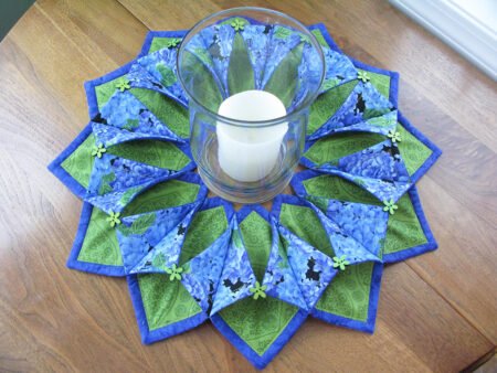 Top US quilting blog and shop, Kate Colleran Designs, shares about a fellow pattern designer Kris Poor of Poorhouse Quilt Designs. Image of a fabric wreath in green and blue.