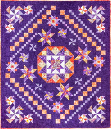 Top US quilting blog and shop, Kate Colleran Designs, shares about her new batik fabric line Winged Things and a FQ giveaway! Image is a block of the month star quilt with a dark purple background and purple, orange yellow and white batiks.