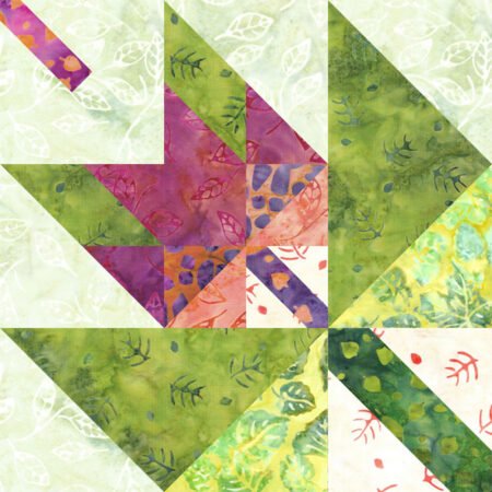 Top US quilting blog and shop, Kate Colleran Designs, shares about her September Block Remix challenge and her new block! Image is of a maple leaf in a maple leaf quilt block with a slash detail made in green, orange pink and purple batiks.