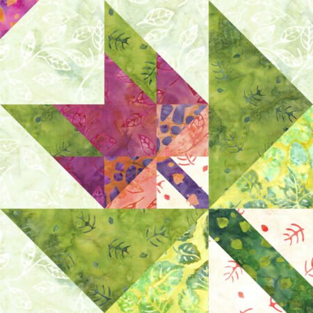 Top US quilting blog and shop, Kate Colleran Designs, shares about her September Block Remix challenge and her new block! Image is of a maple leaf in a maple leaf quilt block with a upper left corner triangle detail made in green, orange pink and purple batiks.