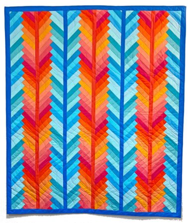 Top US quilting blog and shop, Kate Colleran Designs, shares about her new quilt book called Patchwork Braids and her pre-sale! Image is a striking braid quilt with columns of mixed orange fabrics and columns of mixed blue solid fabrics.