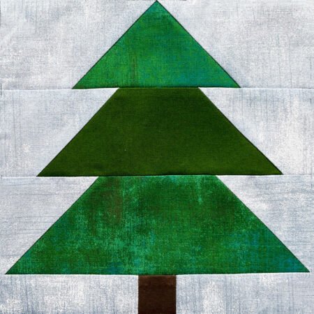Top US quilting blog and shop, Kate Colleran Designs, shares about Block 2 Tannenbaum in the Jingle Bell Pines Block Party! Image is pieced tree block in greens with a light blue background.