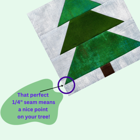 Top US quilting blog and shop, Kate Colleran Designs, shares about Block 2 Tannenbaum in the Jingle Bell Pines Block Party! Image is pieced tree block in greens with a blue background noting the 1/4" seam.
