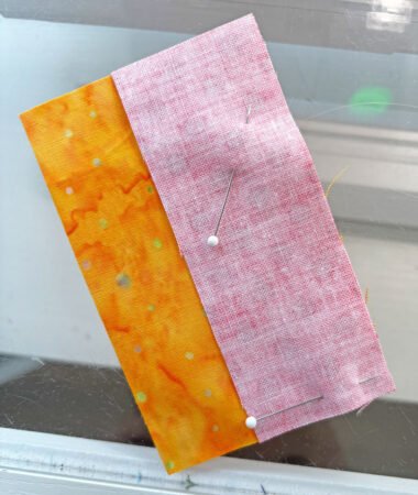 Top US quilting blog and shop, Kate Colleran Designs, shares about Block 4 Gifts Galore in the Jingle Bell Pines BOM Block Party! Image is 2 pieces of fabric layered together with pins
