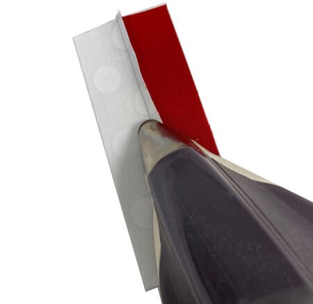 Jingle Bell Pines BOM Block Party Block 5 Jingle Socks! Image is a red and white strips set with the tip of the iron pressing the seam on the back of the strip set.