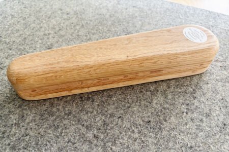 Top US quilting blog and shop, Kate Colleran Designs, shares about the Jingle Bell Pines BOM Block Party Block 5 Jingle Socks! Image is a wooden pressing clapper on a wall mat.