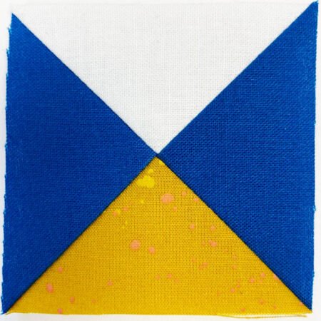 Top US quilting blog and shop, Kate Colleran Designs, shares about the Jingle Bell Pines Block Party Block 7 Rose Star. Image is the front of a quarter square triangle unit in blue, white and gold.