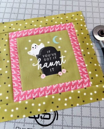 Top US quilting blog and shop, Kate Colleran Designs, shares about new projects using quilt blocks and how to resize. Image is a green Halloween panel with a ghost with pink and green borders.