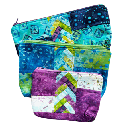 Top US quilting blog and shop, Kate Colleran Designs, shares about her new batik line called Garden Gate and a FQ bundle giveaway! Image shown is a trio of small quilted bags in blue, green and magenta batiks.