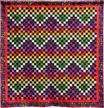 quilt made of squares in lines of color in yellows, reds, oranges, purples and green with a dark blue print border