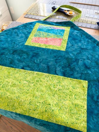 an apron laid out on the cutting table