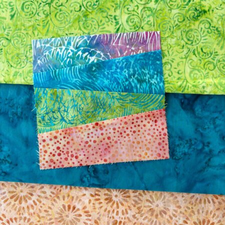 angled striped quilt block on top of coordinating fabrics