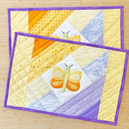 2 placemats with appliquéd butterflies in spring colors