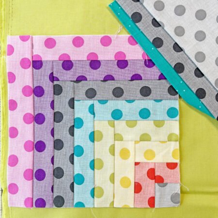 a log cabin block and coordinating fabric