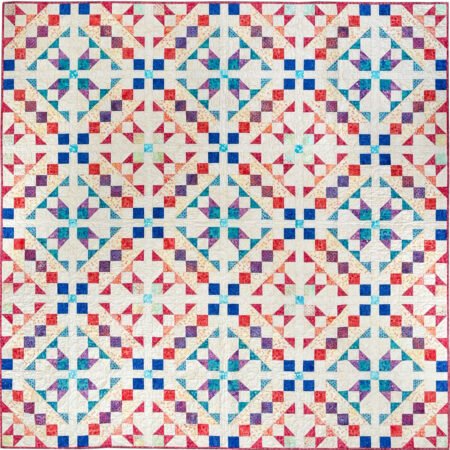 Starbound quilt in Groovy batiks in blues, creams, red, orange, aqua and purple with HST units and chains of squares criss crossing the quilt